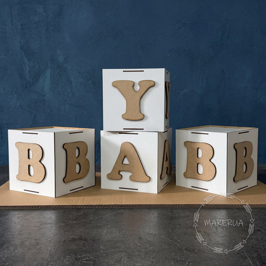 White blocks with brown letters BABY for birthday party, from MakerUA 