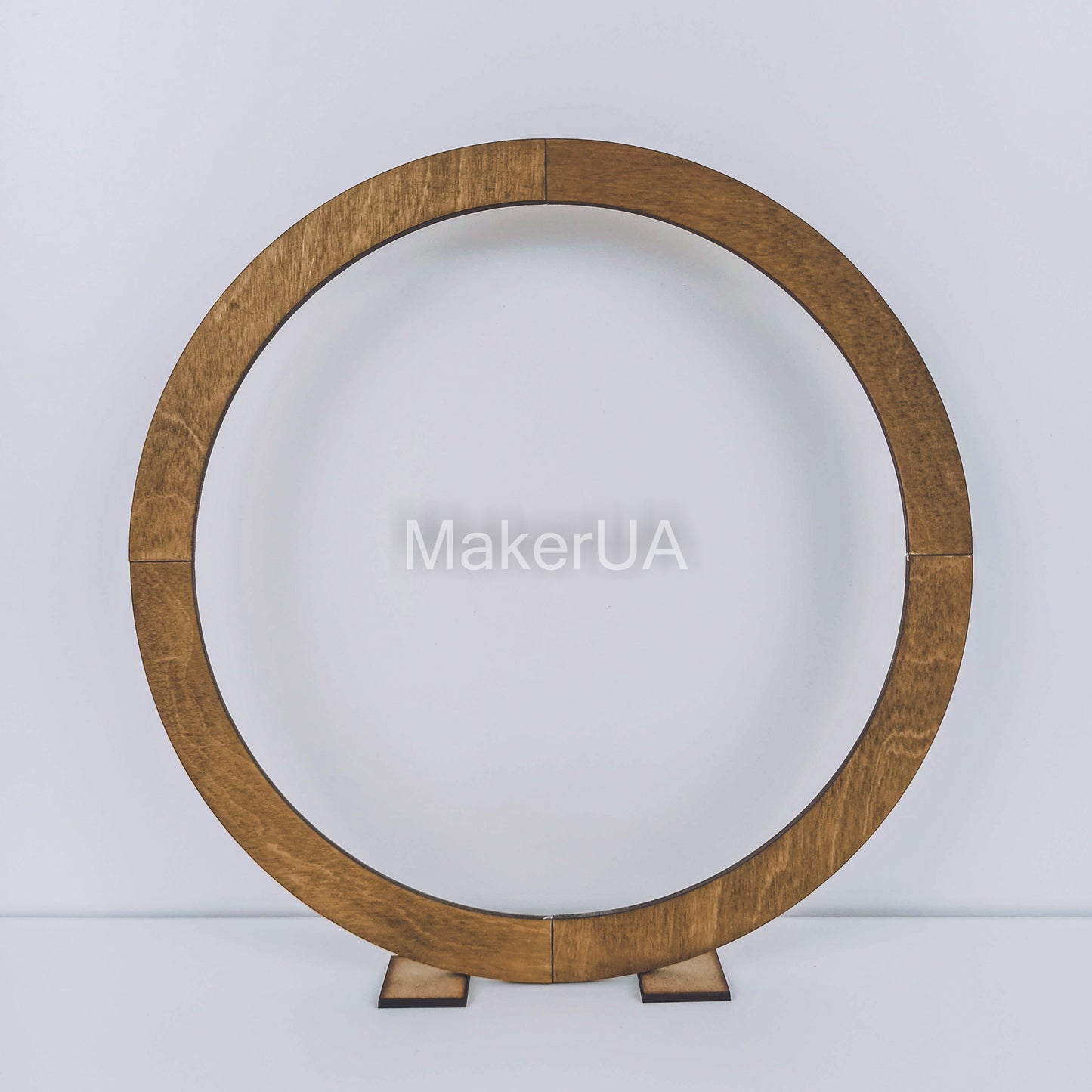 Large open round wooden hoop arch with a natural brown wood finish. Classic circle backdrop frame for rustic boho weddings and event balloon garlands.