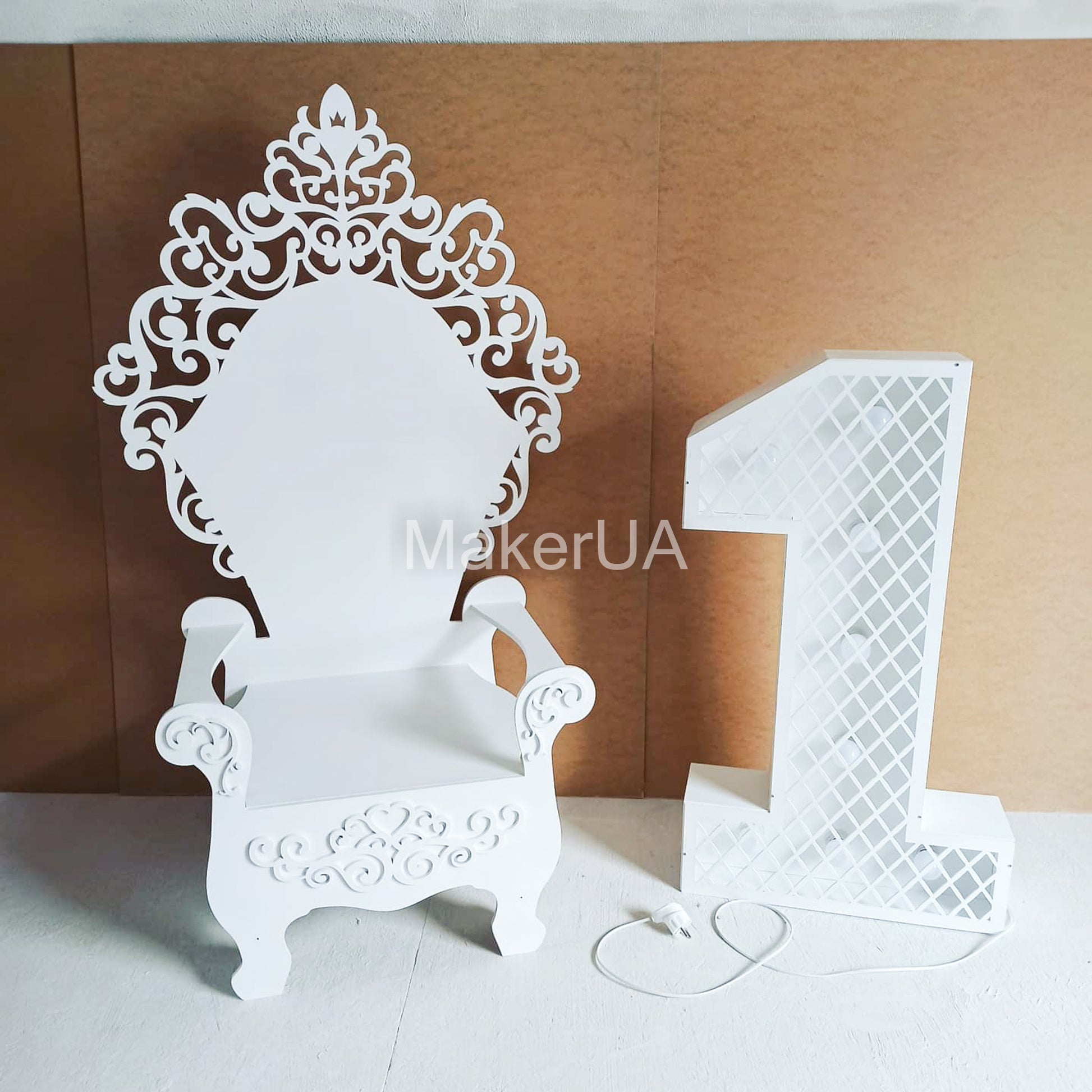 White ornate wooden throne chair with elegant filigree design, decorated for a Christmas party photo zone. Classic royal seating for holiday events and birthday props.